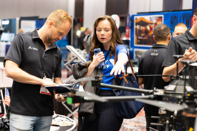 A conversation on the exhibit hall floor at Commercial UAV Expo 2025.